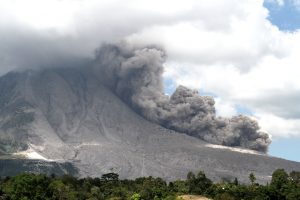 Awan panas meluncur dari puncak Gunung Sinabung ketika terjadi guguran kubah lava terlihat dari Desa Tiga Pancur, Karo, Sumatera Utara, Minggu (10/1). Aktivitas vulkanis Gunung Sinabung masih relatif tinggi, ditandai dengan adanya luncuran awan panas dan erupsi yang masih terus terjadi. ANTARA FOTO/Rony Muharrman/pd/16